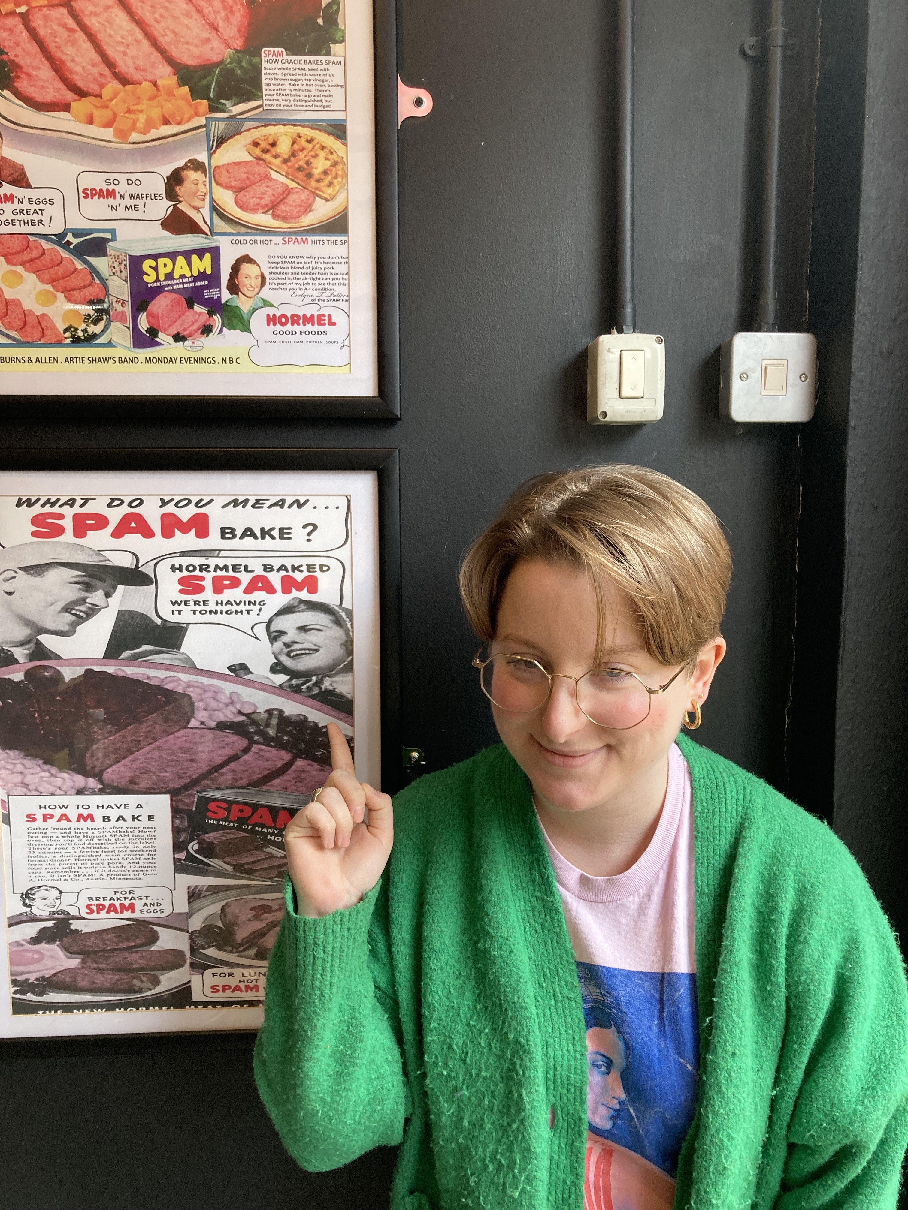 Clodagh pointing at a SPAM poster.